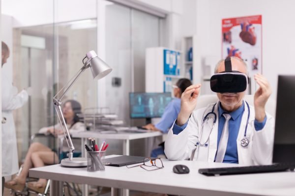 Senior doctor wearing virtual reality headset